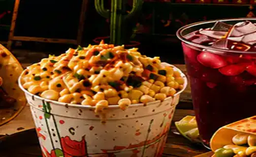 Cup of Mexican esquite with chile and lime